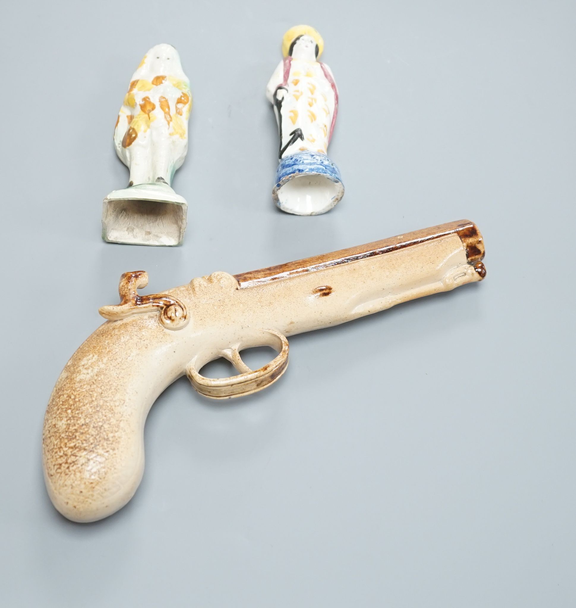 Two prattware figures circa 1800. and a salt-glazed pistol 25cm